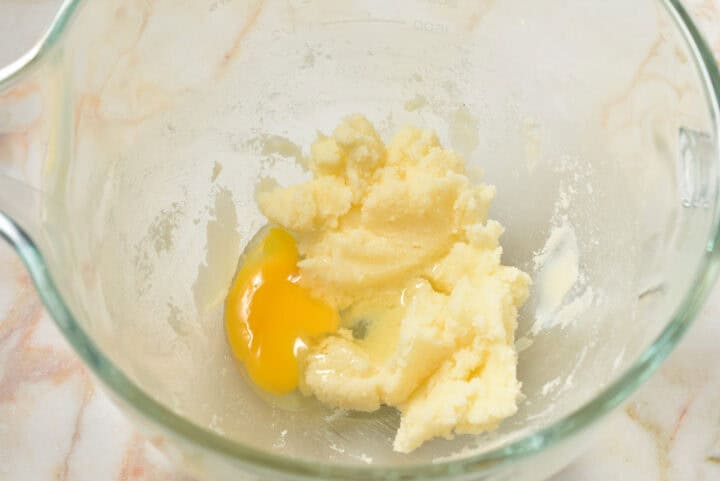 creamed butter and sugar in a bowl with an egg.