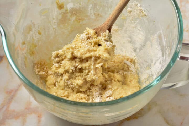 process shot of cake batter with creamed butter and sugar with dry ingredients.