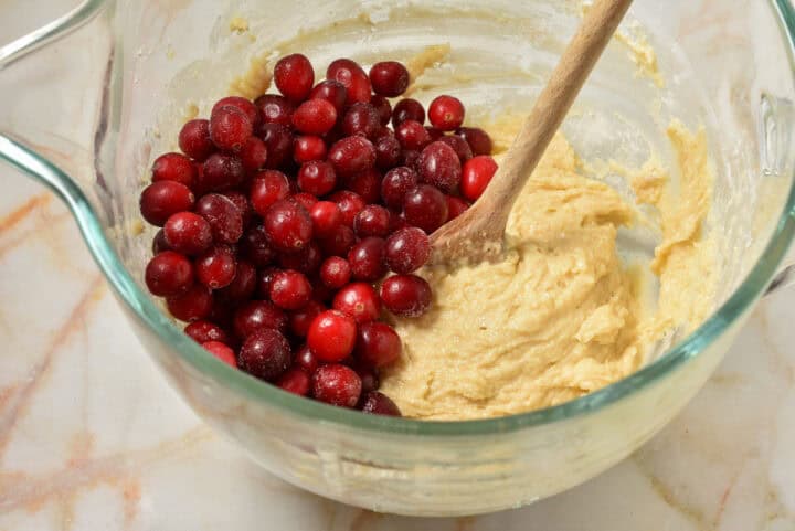 process shot of dough with cranberries.