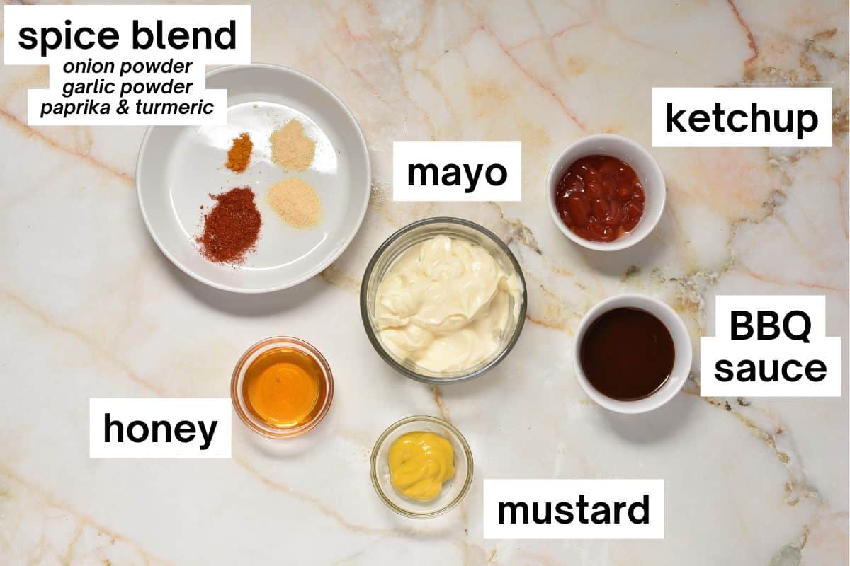 ingredients for sauce on the counter, including mayo, ketchup, mustard, honey, and spices.