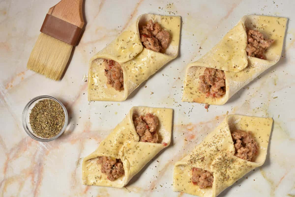 sprinkling the pastry with Italian seasoning.