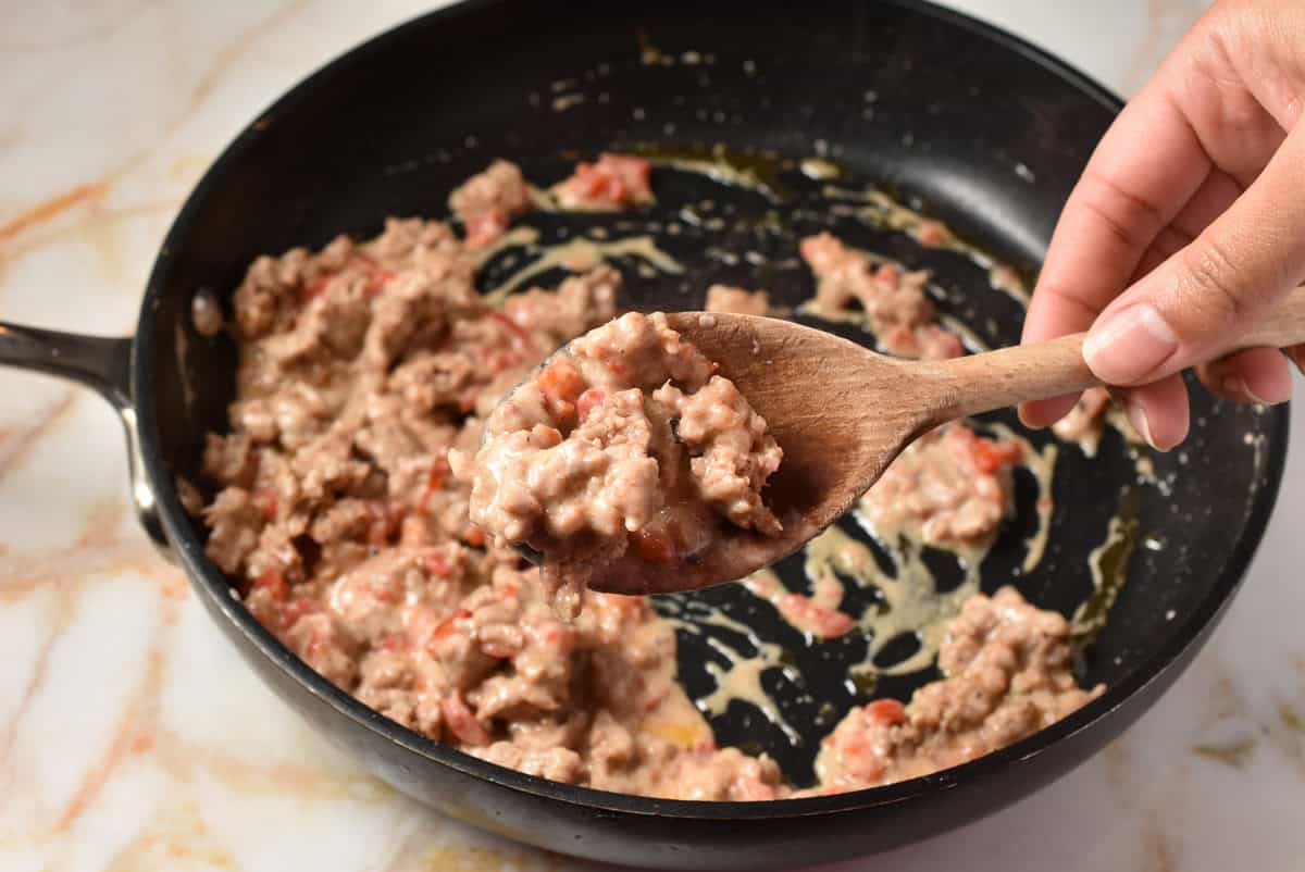 turkey sage filling mixed together with some on a spoon.