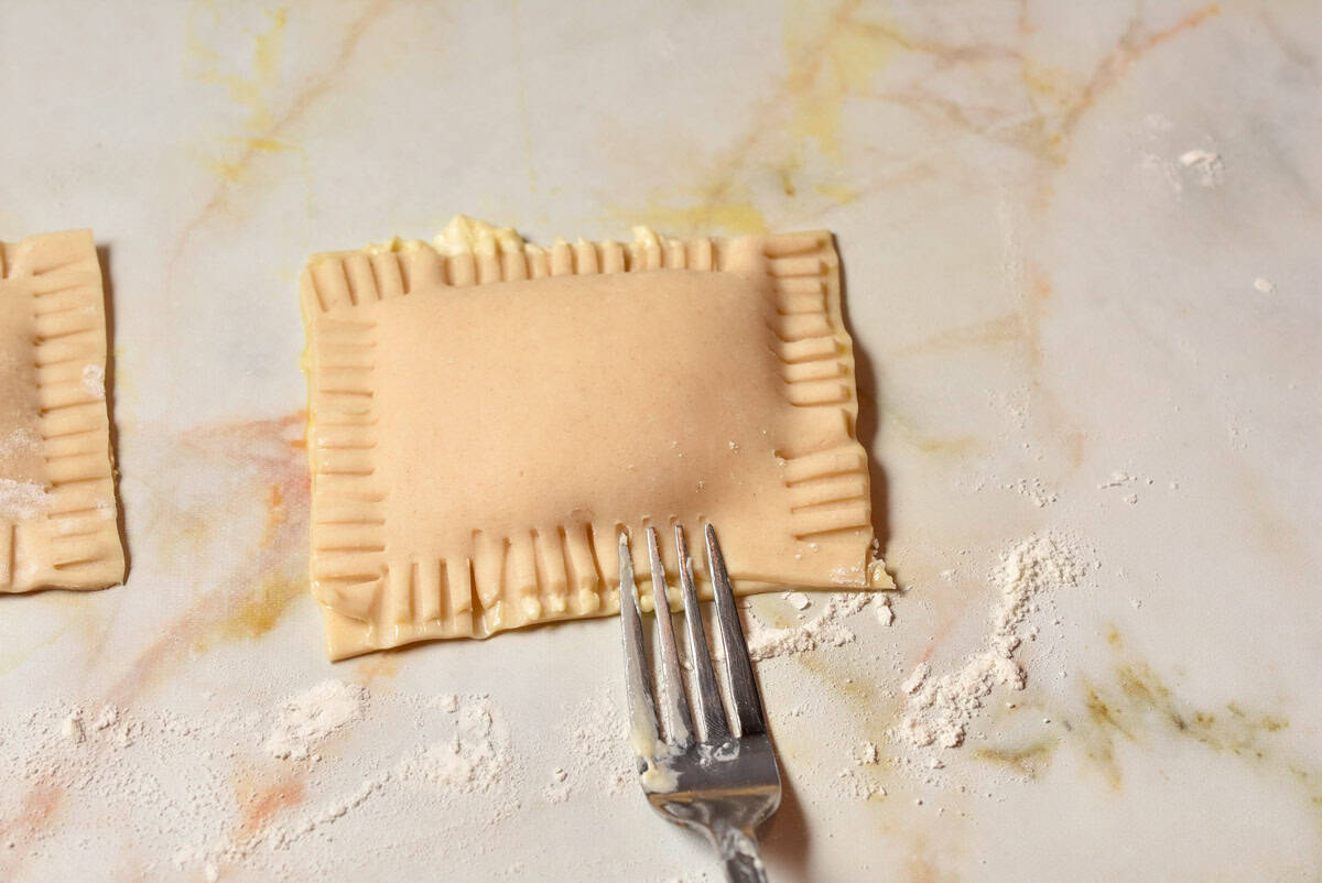 A fork crimping the edges of the holidays pie.