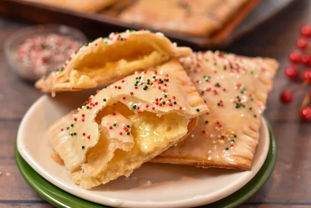 A holiday pie broken in half, with a creamy custard inside and holiday sprinkles on the outside.