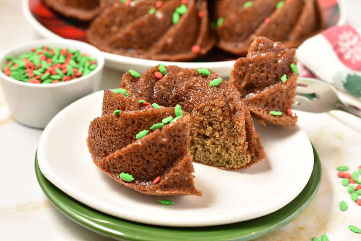 bite of toffee cake on a fork with the mini bunt sitting on a plate.