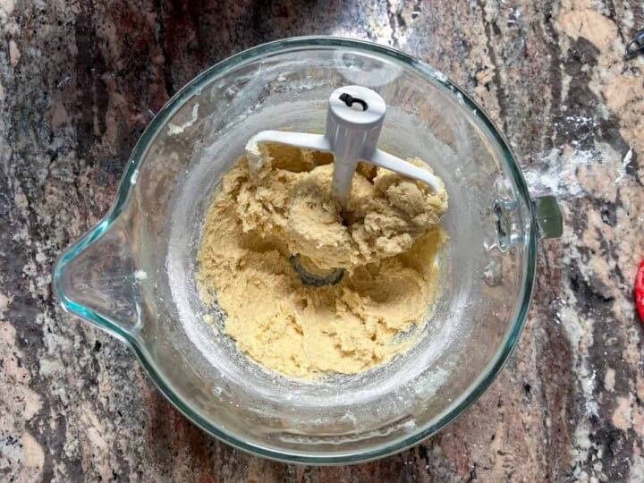 sugar cookie dough in a clear mixer.