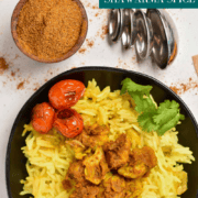 A black bowl filled with rice, roasted tomatoes, and spiced meat sits beside a bowl of spice powder and three measuring spoons. The text reads Hella Fresh Shawarma Spice Blend, highlighting the perfect mix for an authentic taste experience.