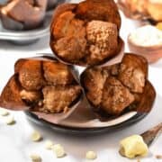 Four Starbucks Copycat Cinnamon Pull-Apart Bread muffins on a plate with white chocolate chips and butter, plus step-by-step preparation images shown below. Text reads Starbucks Copycat Cinnamon Pull-Apart Bread.
